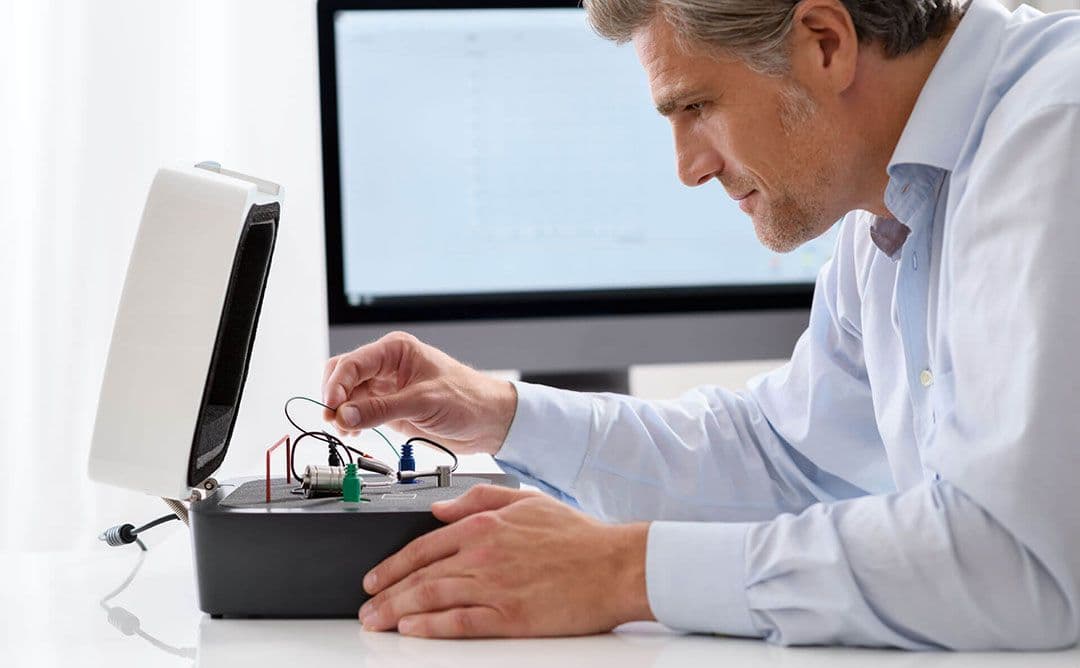 Doctor using the AVANT Hearing Instrument Test Chamber